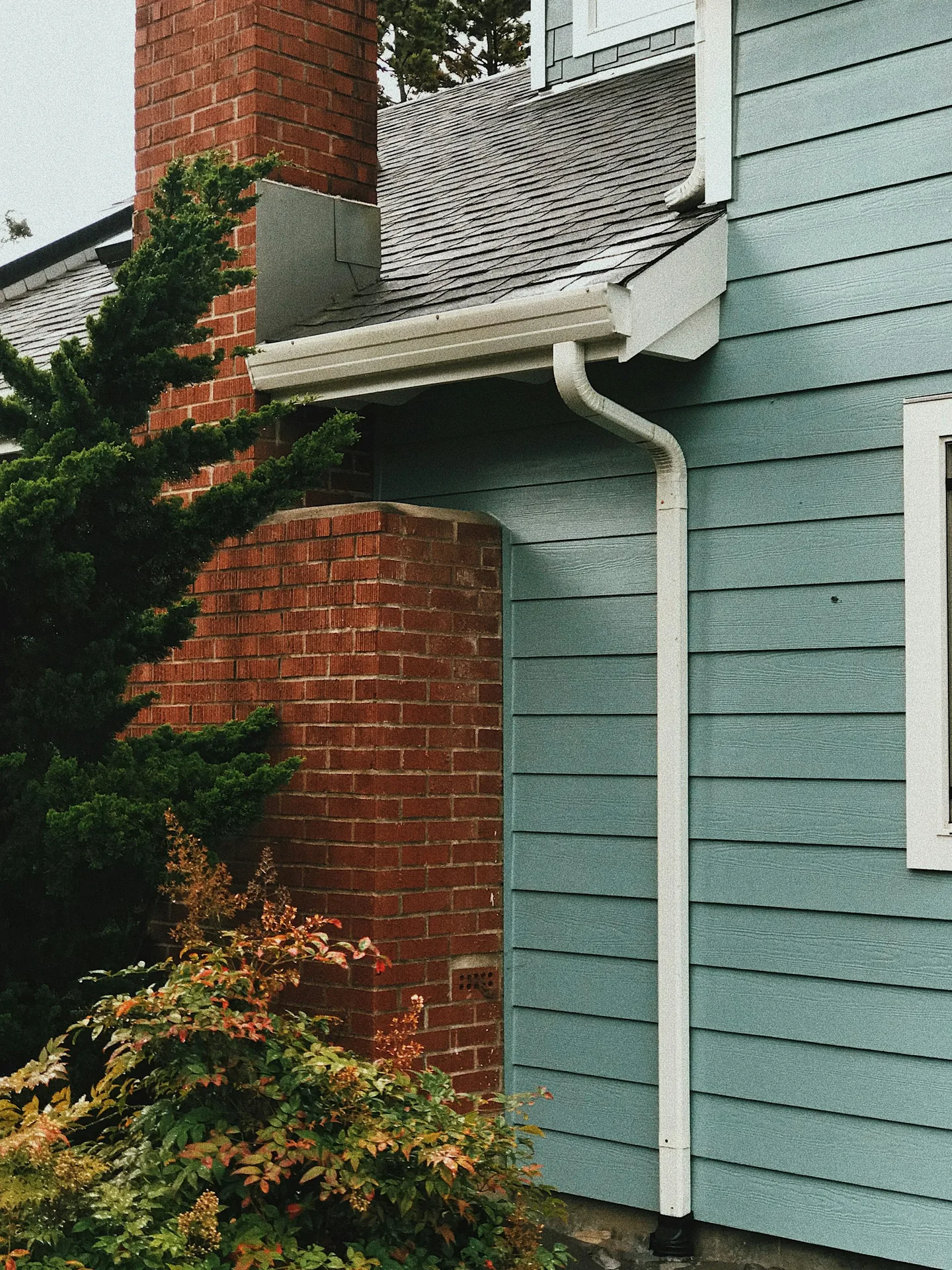 Crisp white trim and fascia on blue siding